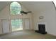 Bright living room featuring tall windows, fireplace, and vaulted ceiling at 3336 Harvester Woods Rd, Decatur, GA 30034