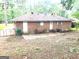 The back exterior has a small patio with chairs, two doors and an exterior air conditioning unit on the side at 10178 Top Tree Ct, Jonesboro, GA 30238