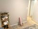 Basement area with exercise equipment, yoga mat, storage shelves and neutral carpet at 10178 Top Tree Ct, Jonesboro, GA 30238