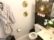 Stylish bathroom showcasing a vanity with gold accents, floral arrangements, and decorative mirrors at 10178 Top Tree Ct, Jonesboro, GA 30238