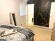Stylish bedroom with a cozy bed, a statement wall, and ample natural light at 10178 Top Tree Ct, Jonesboro, GA 30238