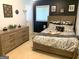 Serene bedroom with a comfortable bed, a classic dresser, and stylish wall decor at 10178 Top Tree Ct, Jonesboro, GA 30238