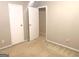 Empty bedroom with neutral carpet, white trim and two closets at 10178 Top Tree Ct, Jonesboro, GA 30238