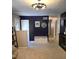 View of an entry area featuring blue accent wall, console table, and modern lighting at 10178 Top Tree Ct, Jonesboro, GA 30238