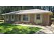 Charming brick home with a well-maintained lawn, complemented by a light green front door and traditional shuttered windows at 10178 Top Tree Ct, Jonesboro, GA 30238