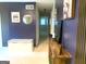 Inviting hallway with storage bench, decorative mirror, and stylish blue accent wall at 10178 Top Tree Ct, Jonesboro, GA 30238