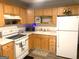 Well-lit kitchen showcasing light wood cabinets and essential appliances at 10178 Top Tree Ct, Jonesboro, GA 30238