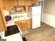 Functional kitchen featuring wooden cabinets, white appliances, and tile countertops at 10178 Top Tree Ct, Jonesboro, GA 30238