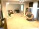 Open living area with abundant natural light, plush carpeting, a comfortable seating area, and a dedicated workspace for functionality at 10178 Top Tree Ct, Jonesboro, GA 30238
