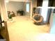 Open living area with abundant natural light, plush carpeting, a comfortable seating area, and a dedicated workspace for functionality at 10178 Top Tree Ct, Jonesboro, GA 30238