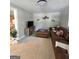 Cozy living room featuring a comfortable leather sectional, a modern TV setup, and neutral decor, creating a relaxing atmosphere at 10178 Top Tree Ct, Jonesboro, GA 30238