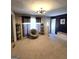 Inviting living room featuring plush carpet, a unique swivel chair, neutral walls, and decorative shelving, showcasing ample space at 10178 Top Tree Ct, Jonesboro, GA 30238