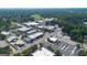 Captured aerial showcasing the town's layout, featuring streets, buildings, trees, and a cemetery at 357 W Hightower Trl, Social Circle, GA 30025