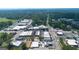 Aerial view showing a charming downtown area with a mix of commercial buildings and lush greenery at 357 W Hightower Trl, Social Circle, GA 30025