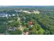 An aerial view of a charming home nestled amongst lush trees with a long street in the distance at 357 W Hightower Trl, Social Circle, GA 30025
