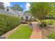 Backyard with privacy landscaping, brick pathway, steps, and mature trees at 357 W Hightower Trl, Social Circle, GA 30025