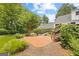 View of backyard, brick patio, landscaping, and a bridge to the home at 357 W Hightower Trl, Social Circle, GA 30025