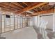 Unfinished basement with exposed beams, support posts and concrete floor at 357 W Hightower Trl, Social Circle, GA 30025