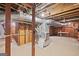 Unfinished basement with exposed ductwork, framing and concrete floor at 357 W Hightower Trl, Social Circle, GA 30025