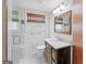 Bathroom featuring glass shower, dark wood vanity, and new light fixtures at 357 W Hightower Trl, Social Circle, GA 30025