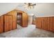 An attic bedroom with wood paneling and carpet flooring provides a cozy space at 357 W Hightower Trl, Social Circle, GA 30025