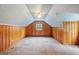 Attic bedroom offers paneled walls, carpeted flooring, and a ceiling fan at 357 W Hightower Trl, Social Circle, GA 30025