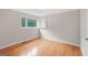 A cozy bedroom with hardwood floors, a window, and a built-in shelf provides ample storage at 357 W Hightower Trl, Social Circle, GA 30025