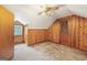 Cozy bedroom features paneled walls, carpet floors, and a ceiling fan for added comfort at 357 W Hightower Trl, Social Circle, GA 30025