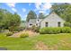 Charming white home with a brick walkway, mature landscaping, and a lush green lawn at 357 W Hightower Trl, Social Circle, GA 30025
