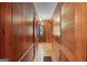 Hallway with paneled wood walls and a decorative front door creates a warm, inviting entrance to the home at 357 W Hightower Trl, Social Circle, GA 30025
