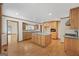 Open-concept kitchen with hardwood floors, an island, and lots of cabinet space at 357 W Hightower Trl, Social Circle, GA 30025