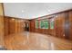 Wood-paneled living room with hardwood floors and a large window providing a view of the outdoors at 357 W Hightower Trl, Social Circle, GA 30025