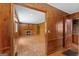 Open-concept living room featuring hardwood floors, a fireplace, and wood paneled walls at 357 W Hightower Trl, Social Circle, GA 30025