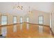 Large living area featuring vaulted ceilings, hardwood floors, and natural light at 357 W Hightower Trl, Social Circle, GA 30025