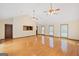 Bright, open-plan living room with gleaming hardwood floors and ceiling fans at 357 W Hightower Trl, Social Circle, GA 30025