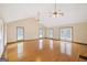 Spacious living room with hardwood floors, vaulted ceiling, and three ceiling fans at 357 W Hightower Trl, Social Circle, GA 30025