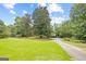 Sprawling lawn with mature trees, offering privacy and a serene setting around the home at 357 W Hightower Trl, Social Circle, GA 30025