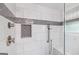 This bathroom features a glass shower with white tile walls and a decorative inset at 357 W Hightower Trl, Social Circle, GA 30025