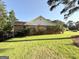 Spacious backyard showcasing a well-manicured lawn and mature trees providing shade and privacy at 601 Clubland Se Cir, Conyers, GA 30094