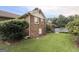 Backyard view with pool, brick home, and green grass at 601 Clubland Se Cir, Conyers, GA 30094