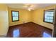 Bright bedroom with gleaming wood floors, ceiling fan, and two windows at 601 Clubland Se Cir, Conyers, GA 30094