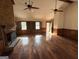 Spacious living room with hardwood floors, fireplace, and multiple ceiling fans at 601 Clubland Se Cir, Conyers, GA 30094