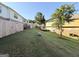 Large sloping backyard with grass and a wooden fence around the perimeter at 1650 Larkspur Trl, Conyers, GA 30012