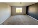 Large bedroom with carpet and a window overlooking the backyard at 1650 Larkspur Trl, Conyers, GA 30012