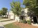 Well maintained townhomes with light colored brick and green landscaping at 1650 Larkspur Trl, Conyers, GA 30012