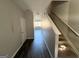 Hallway view featuring stairs and a hardwood-style floor at 1650 Larkspur Trl, Conyers, GA 30012
