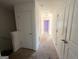 Hallway with three white doors, light-colored carpet, and neutral walls at 1650 Larkspur Trl, Conyers, GA 30012