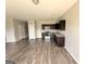 Open floor plan featuring the kitchen with dark wood cabinets and stainless steel appliances at 1650 Larkspur Trl, Conyers, GA 30012