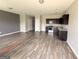Spacious kitchen and living room with hardwood-style floors and an open floor plan at 1650 Larkspur Trl, Conyers, GA 30012