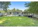 A home with a well-maintained backyard featuring lush green grass surrounded by mature trees and shrubbery at 340 Loblolly Rdg, Locust Grove, GA 30248